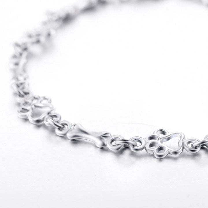 Pulsera con Colgantes de Pata de Perro y Hueso en Plata Pura