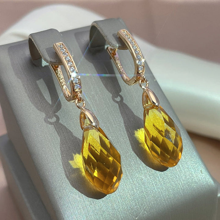 Elegantes pendientes de cristal amarillo y oro