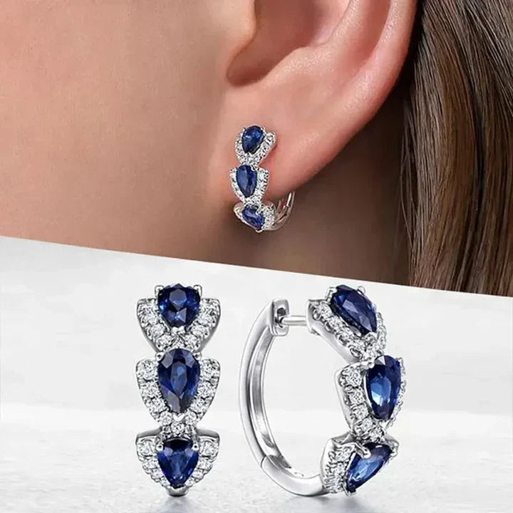 Pendientes con escudo real y piedras preciosas
