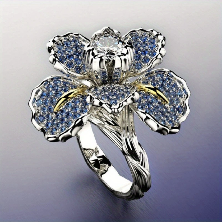 Anillo de plata con flor azul y cristal