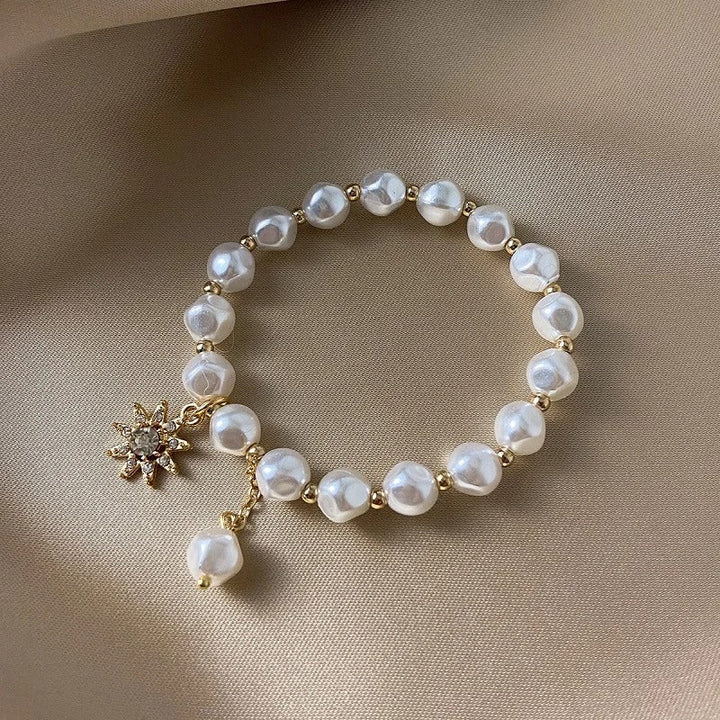 Pulsera con colgante en oro blanco, perla y girasol