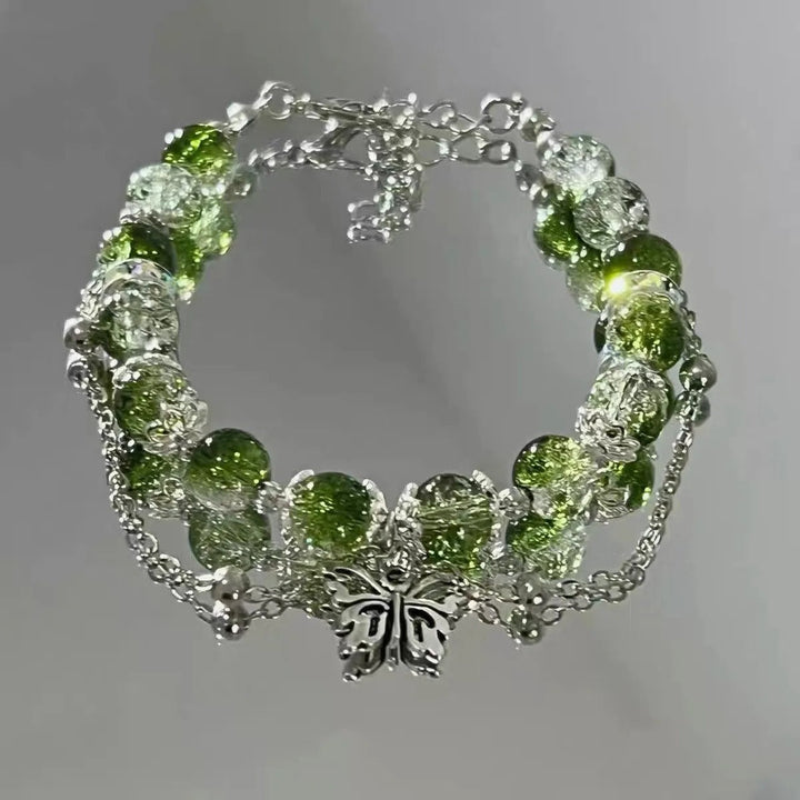 Pulsera vintage con mariposa plateada y cuentas verdes