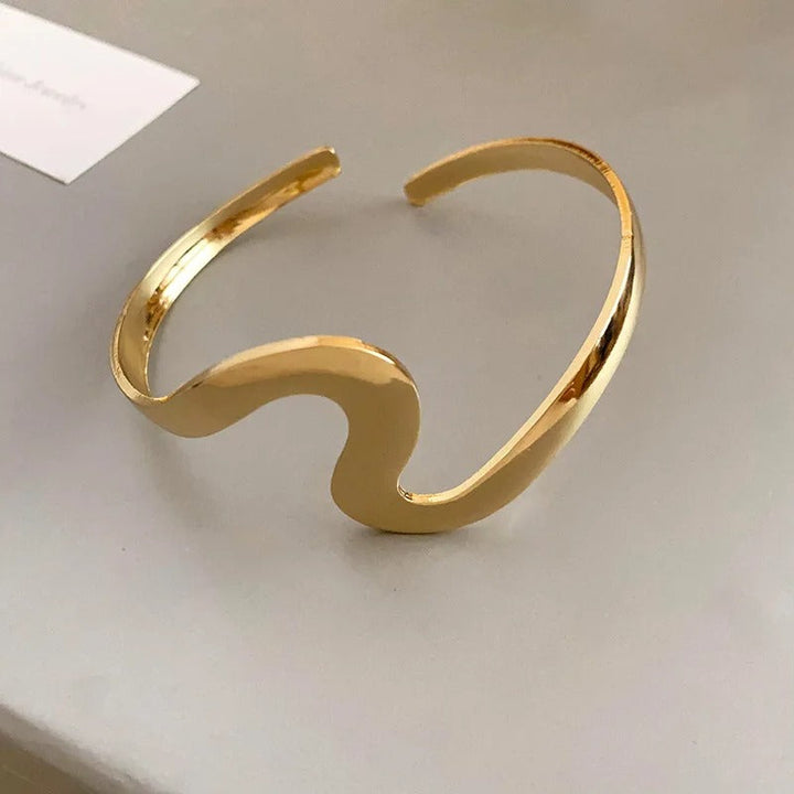 Pulsera clásica abierta con onda dorada